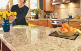 This image shows a woman cleaning a kitchen epoxy countertop.